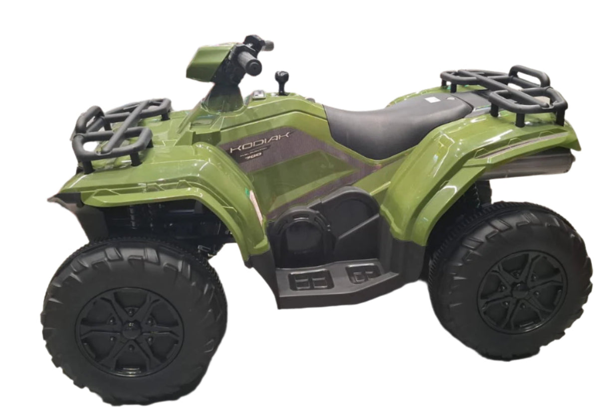 Green toy ATV on display in a store with boxes in the background